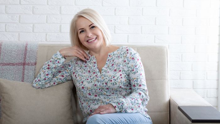 Women sitting on a couch smiling