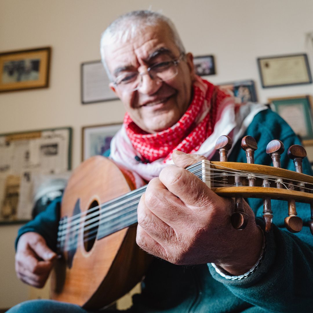 senior man playing guitar