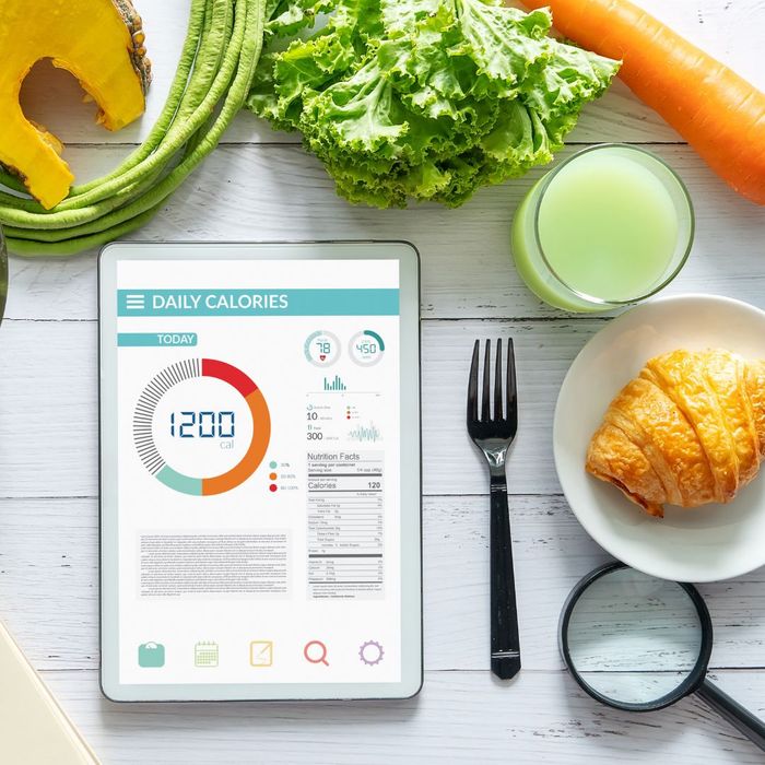 calorie tracker app next to healthy food