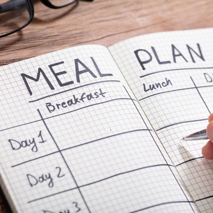 person writing out meal plan