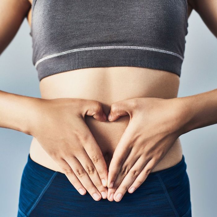 hands forming a heart around stomach