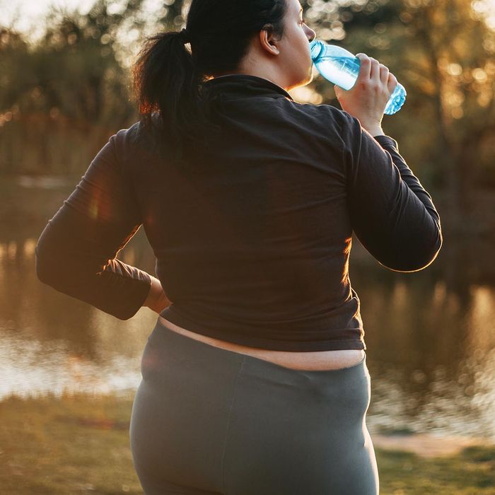 woman drinking water outdoors