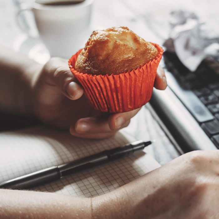 a person holding a muffin