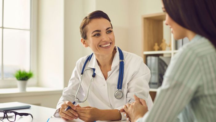 woman talking to a doctor about hrt therapy