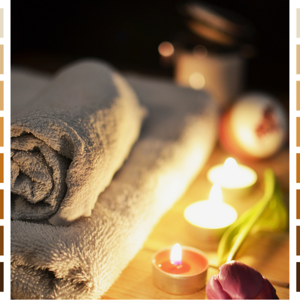 Candles next to rolled towels