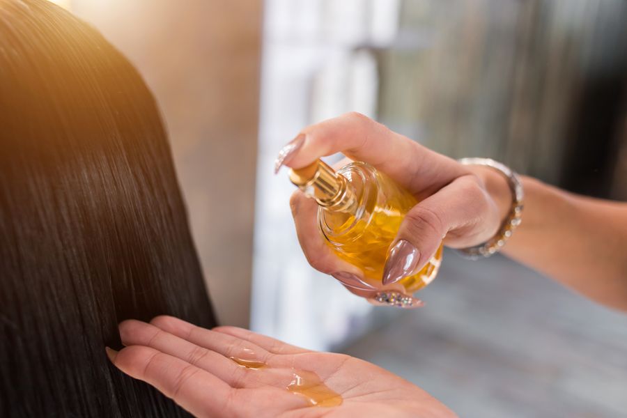 hair oil in hand from glass bottle dreamstime_xxl_119688546.jpg