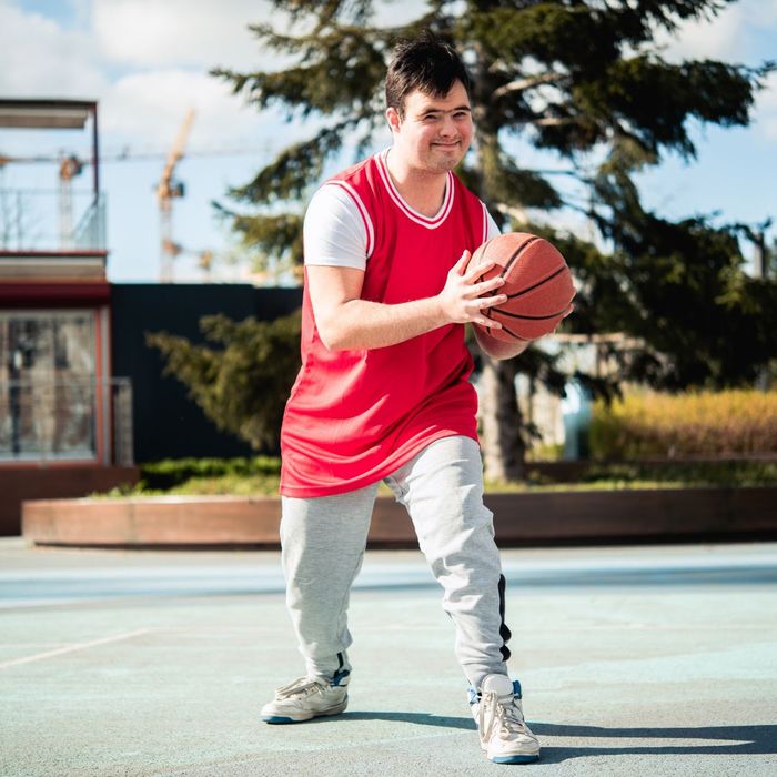man with down syndrome playing basketball