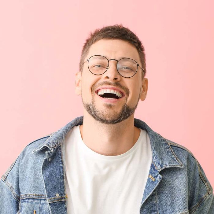 man laughing wearing glasses