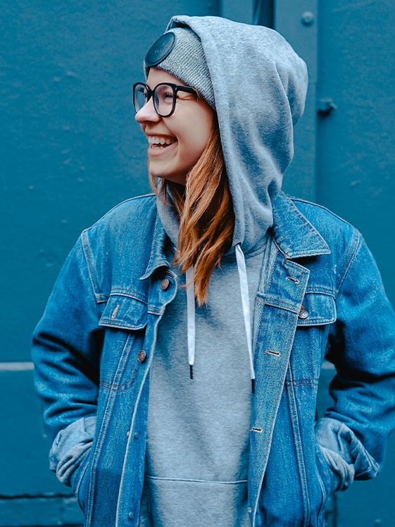 woman wearing glasses and a hooded sweatshirt