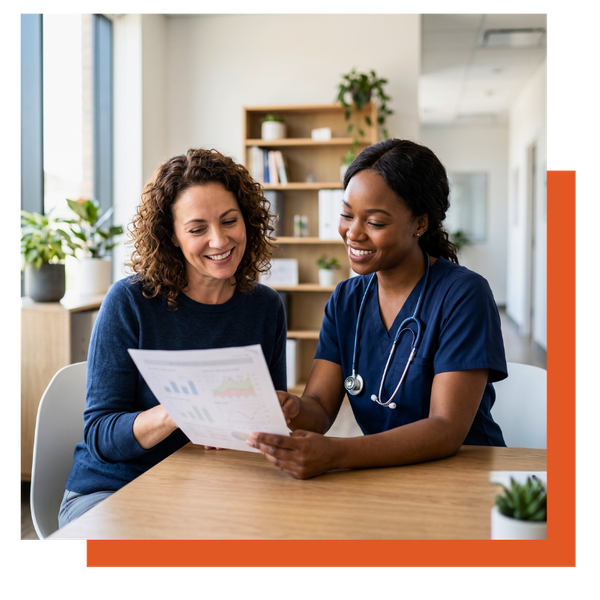 Female medical practitioner reviewing a health chart with a smiling patient.