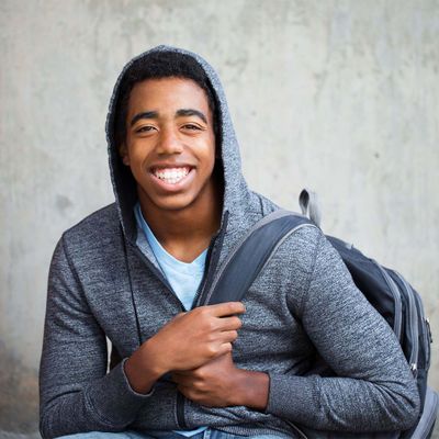 smiling teenage boy wearing backpack