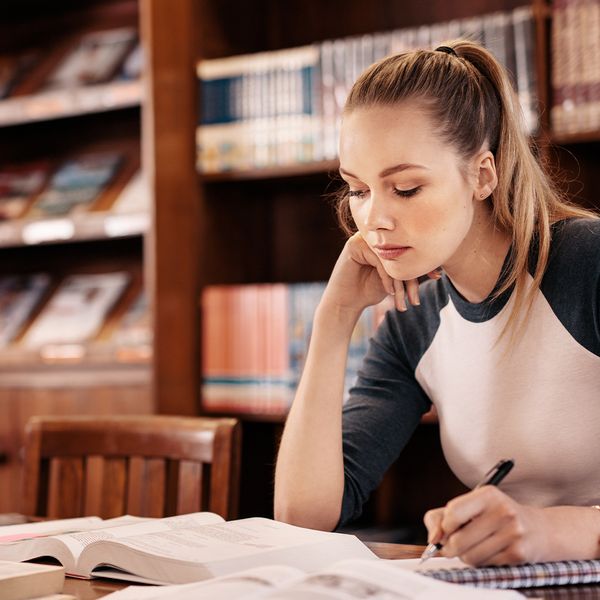 A young woman studies in a quiet library, feeling at ease. studying.jpg