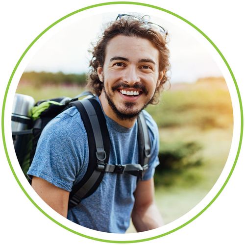 smiling younger man on a hike smiling younger man on a hike