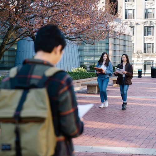 Students walking around college campus.