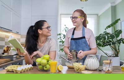 mother cooking with teenage daughter