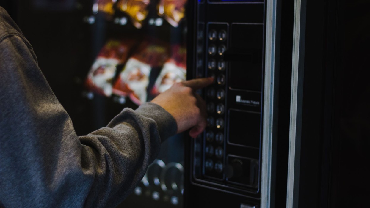 person using a vending machine