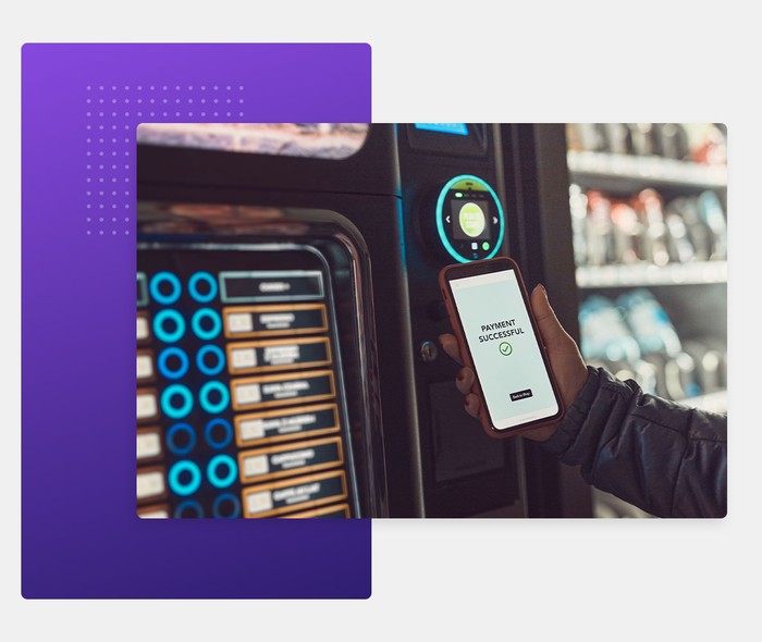 person paying vending machine with phone