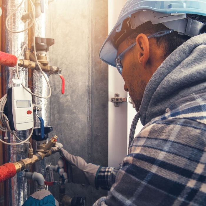 Commercial plumber completing maintenance. 