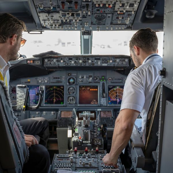 Two pilots inspecting the cockpit