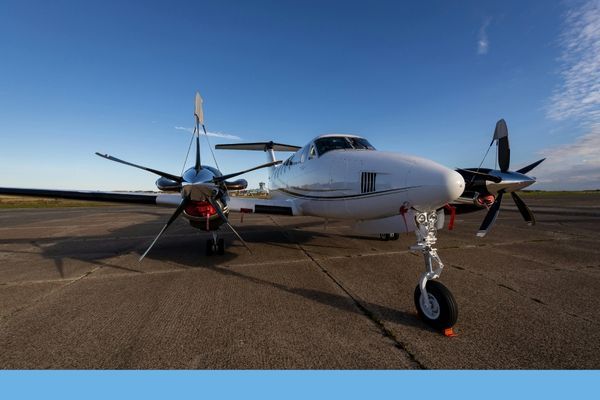 A head-on view of the sleek twin-engine turboprop aircraft (multi-engine time builder) parked on the tarmac.