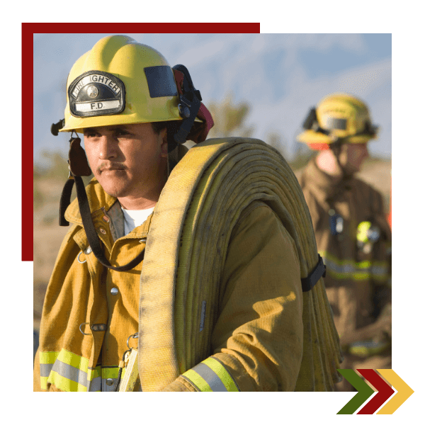 Fire fighter carrying hose