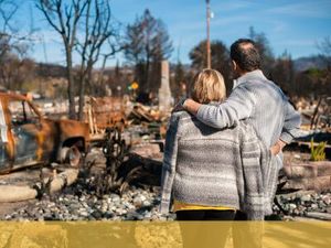 family standing near burnt-down house