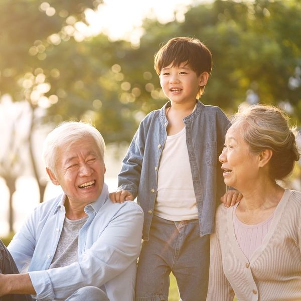 grandparents with grandchild in park