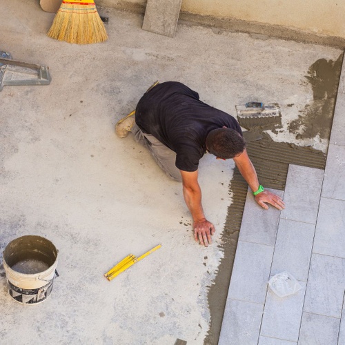worker placing tiles