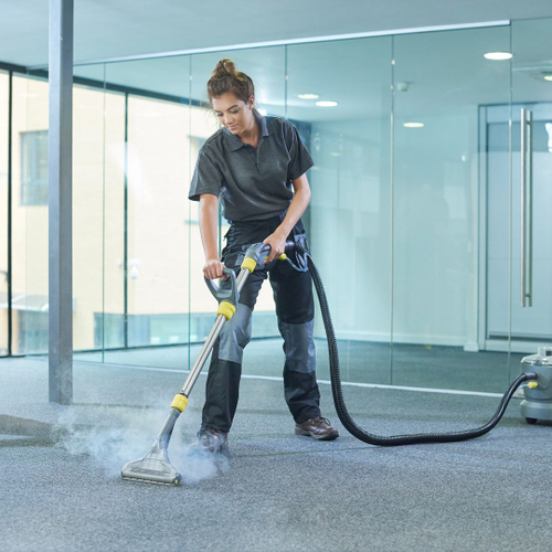 woman cleaning office carpet