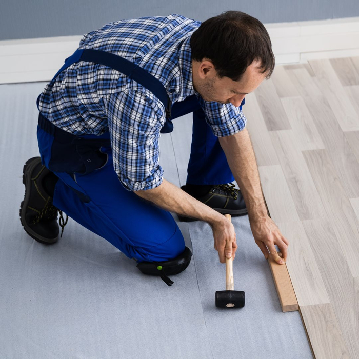 Flooring professional installing flooring.