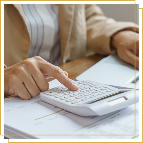 woman typing on calculator