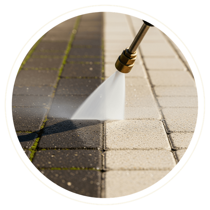 A pressure washer cleaning a dirty paver patio, showing a dramatic before-and-after contrast of the clean surface. A pressure washer cleaning a dirty paver patio, showing a dramatic before-and-after contrast of the clean surface.