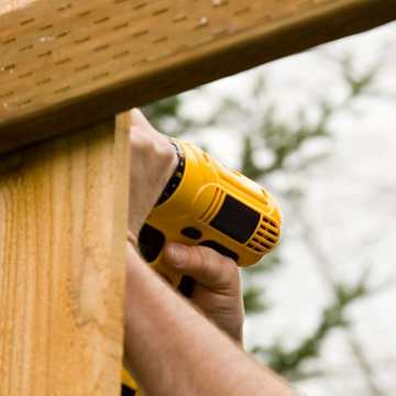 fence being repaired with drill fence being repaired with drill