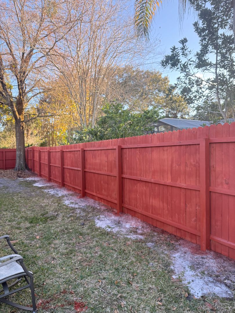 Redwood stained wood privacy fence in Longwood backyard