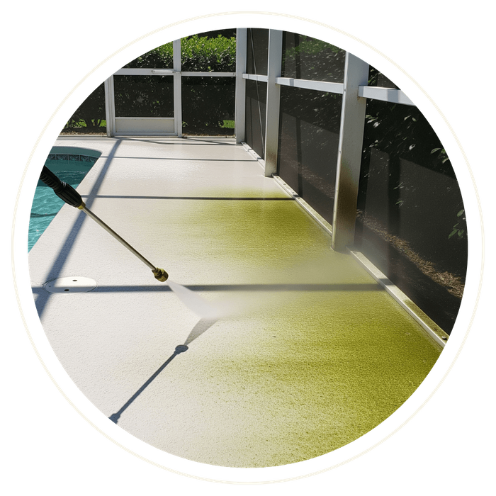 A pressure washer cleans a concrete pool deck inside a screened-in lanai, showing a clear line between the dirty, green-tinted concrete and the clean, bright surface. A pressure washer cleans a concrete pool deck inside a screened-in lanai, showing a clear line between the dirty, green-tinted concrete and the clean, bright surface.