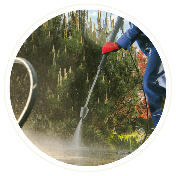 man pressure washing concrete