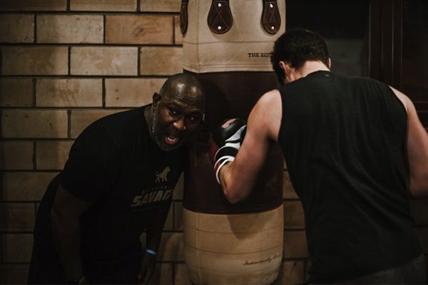Joe training a man that is boxing in the gym