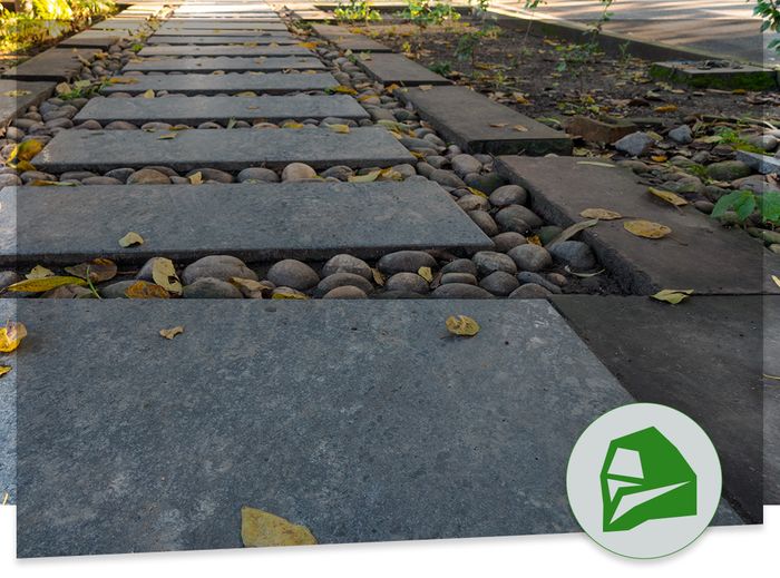 square stone walking path with river stones between slabs