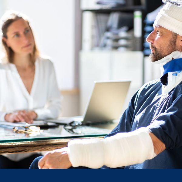 man with injury talking to a lawyer