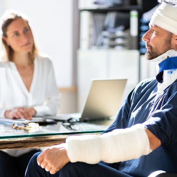 man in neck brace and arm bandage 