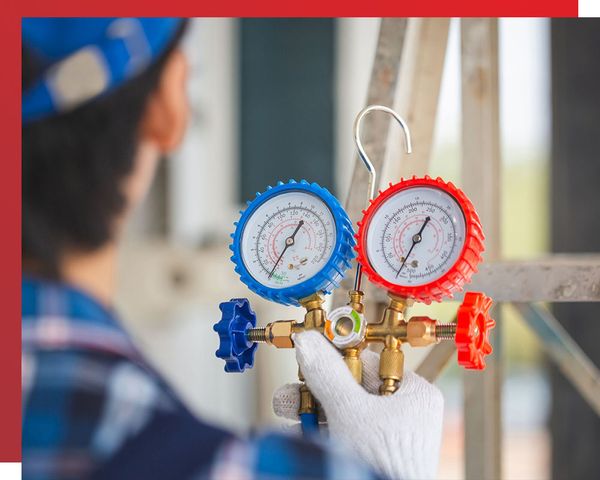 HVAC technician calibrating AC unit