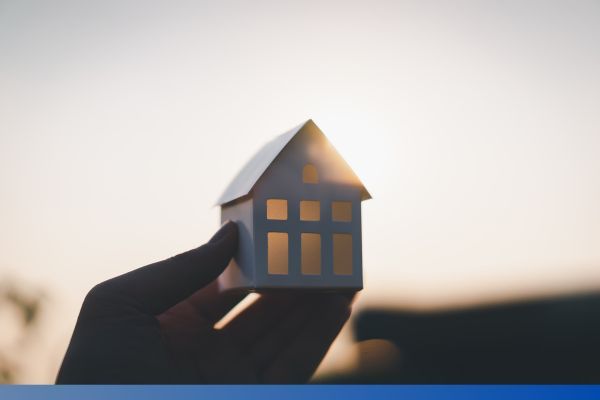 hand holding tiny house hand holding tiny house