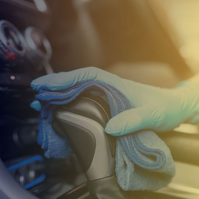 Car interior shifter being cleaned
