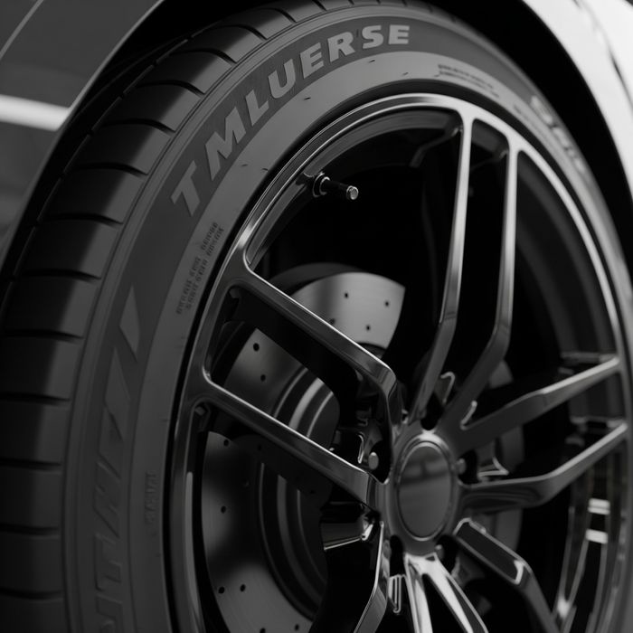 A final shot of a detailed car's wheel and tire, with the tire dressed in a satin black finish and the glossy rim cleaned perfectly.