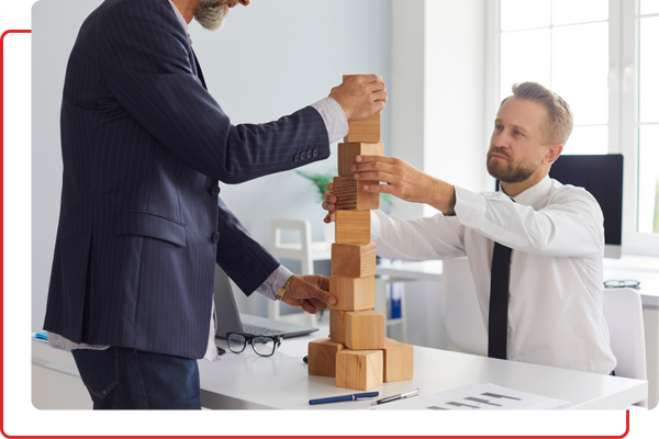 business men stacking blocks