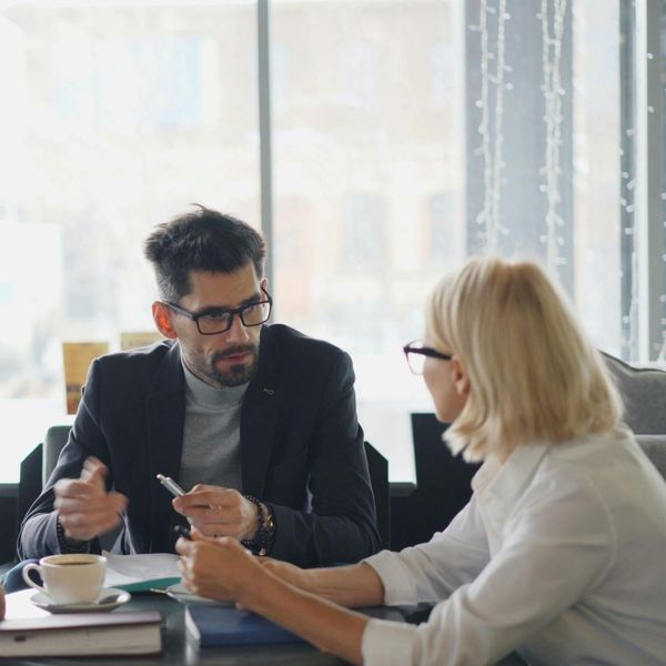 man talking calmly to coworker man talking calmly to coworker