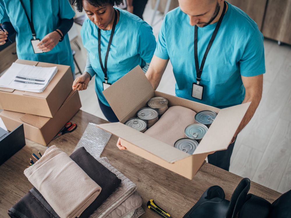 A group of volunteers gathering donations for a charity