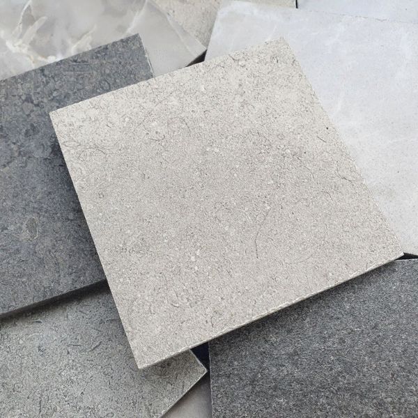 An overhead view shows the rich colors and textures of various stone slabs.