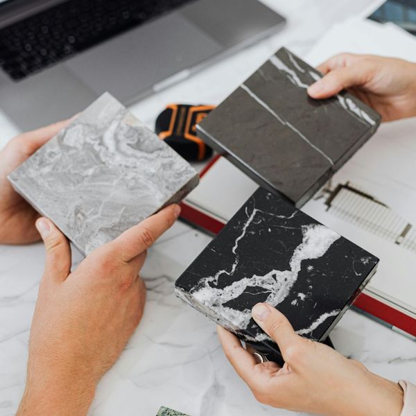 A design expert collaborates with a client, showing them different material options.