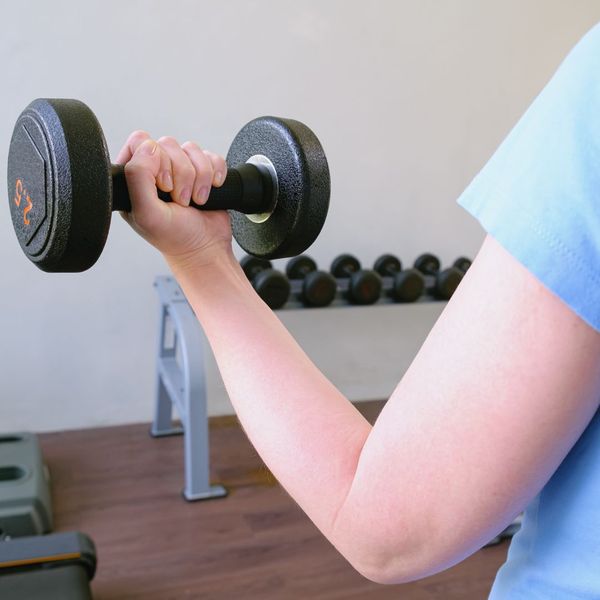 Person doing a bicep curl with a dumbbell. 
